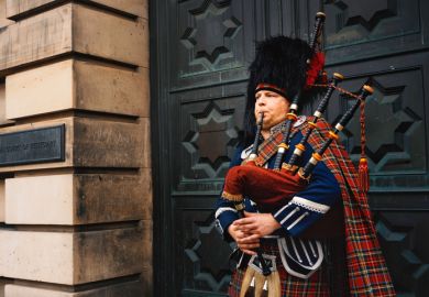 Closeup of a bagpipe street performer at the Royal Mile in Edinburgh