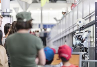 People are listening to the robot introduce itself.