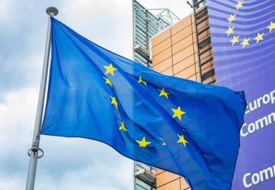 European Union flag in front of the Berlaymont building, headquarters of European Commission.