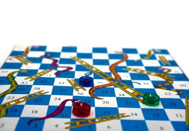 Snakes and ladders board with one counter at the top of a snake, another at the foot of a ladder