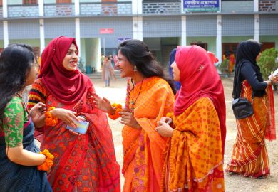 A group of adult students in traditional dress participate in the spring festival celebration.