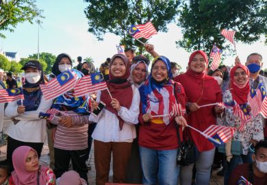 Malaysian raise the Jalur Gemilang Malaysia flag during celebrate Merdeka.