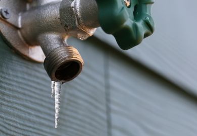 Photo of a frozen exterior faucet (hose bib) with icicles hanging from the end.