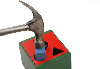Hammer forcing square peg into round hole