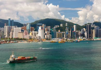 Container Ship and Hong Kong Victoria Harbour Skyline. Container Ship and Hong Kong Victoria Harbour Skyline.
