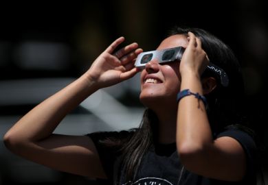 Girl watches solar eclipse