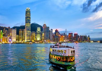 A star ferry in the Victoria Harbour at sunset, Hong Kong, China.