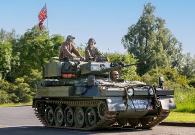  1974 CVR T SCIMITAR military vehicle driving on a British country road.