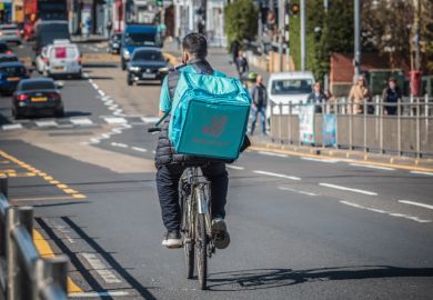 A Deliveroo cycle delivery worker on London street.