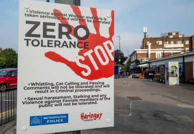  police and local government street sign informing people of their zero tolerance policy of violence and harassment of women.