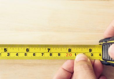 Hand Holding A Tape Measure