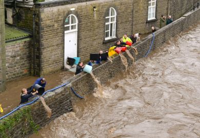 People tipping floodwater out of the basement level of Pontypridd town museum in south Wales People tipping floodwater out of the basement level of Pontypridd town museum in south Wales