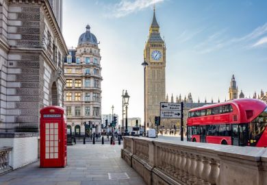 Red telephone box and double-decker bus on Parliament square and Big Ben tower, 