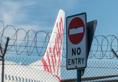 A Virgin Australia Boeing B737-8FE plane parked behind a security fence