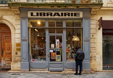 1 person is looking into an old bookstore 1 person is looking into an old bookstore