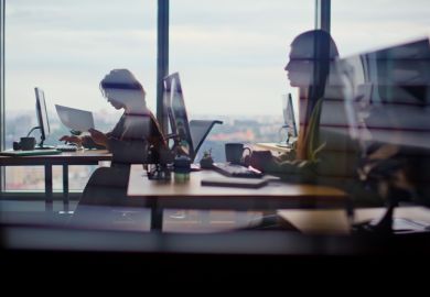 Busy corporate office silhouettes at cityscape window