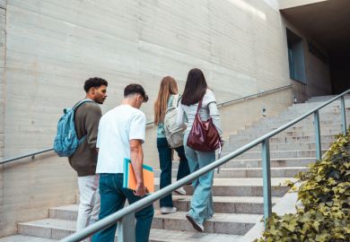 students climbing campus stairs 