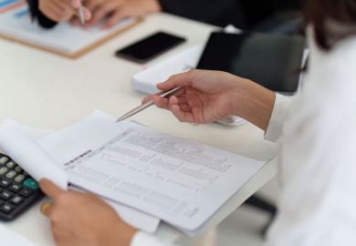 Business woman analysing financial data and paperwork Business woman analysing financial data and paperwork