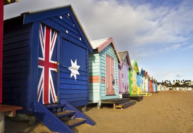 Closed beach huts with Australian flag