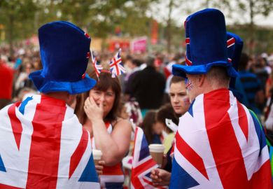 Unknown fans dressed in Union Jack flags and hats in the Olympic Park in Stratford, East London