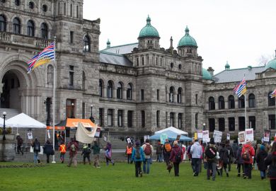 Participants in an Idle No More rally march towards the British Columbia Legislative Building