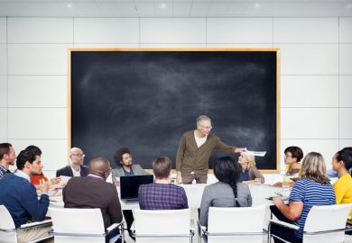 Students gathered around professor Students gathered around professor