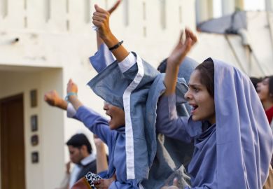 Female muslim students protest at a political rally in Lahore