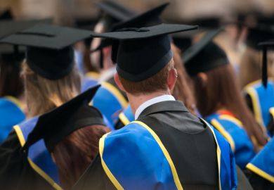  Students sit in a row at their university graduation ceremony.