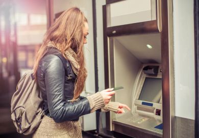 Young woman uses an ATM