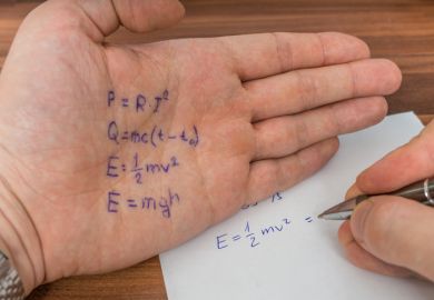 A student in an exam copies from things written on their hand