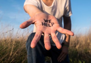 Extended hand with “We help” on the palm, illustrating assistance to international students