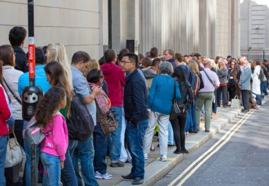 A long queue of people in a street