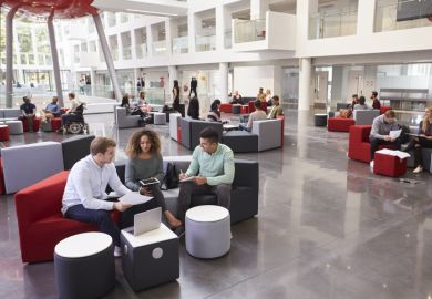 Students sitting in a university atrium