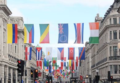 A number of different national flags are displayed above a London street