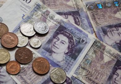 Twenty Pound Notes and coins of pounds sterling the currency of the UK.