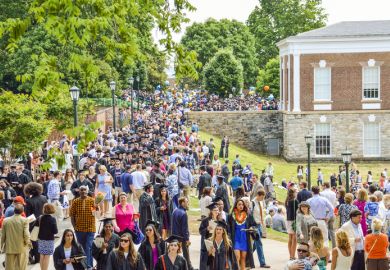  Crowd of people walking by amphitheater at graduation ceremony at University of Virginia