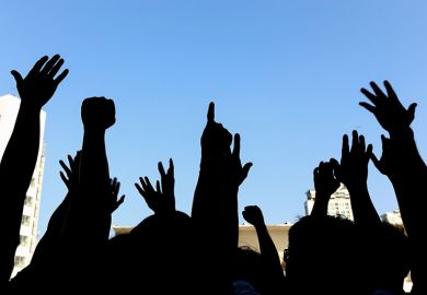 Group of people protesting or marching Group of people protesting or marching