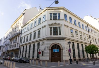 A three-story, beige building in Budapest 