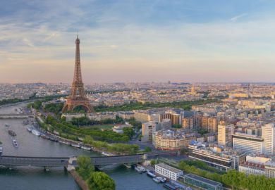 Aerial view of Paris with Eiffel tower during sunset