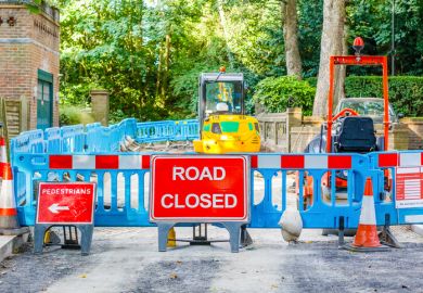 In front of roadworks a sign says 'Road closed'