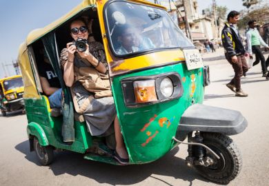 Smiling girl with camera on a tuk-tuk. The smiling girl with camera on a tuk-tuk.