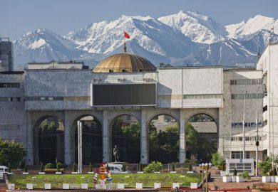 View over the city centre of Bishkek with snow capped mountains in the background.