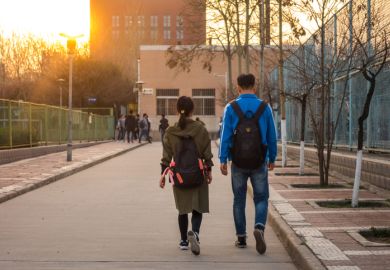 Two students Walking Side by Side on University Campus in Xi'an, China Two students Walking Side by Side on University Campus in Xi'an, China