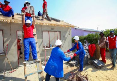 Community members building a low cost house as a team in Soweto.