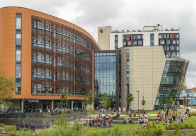 people relaxing on the grounds of De Montfort University