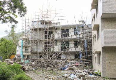 Building collapsing under scaffolding collapse scaffold scaffolding damage destruction construction fall over fall down symbolising collapse of English language colleges