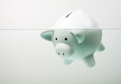 Piggy bank drowning in debt
