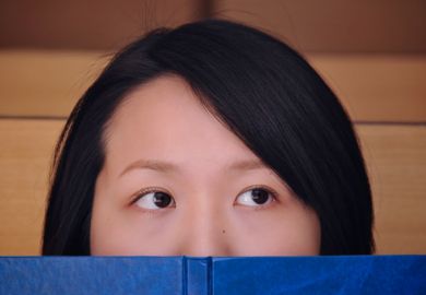 Female Chinese student with book