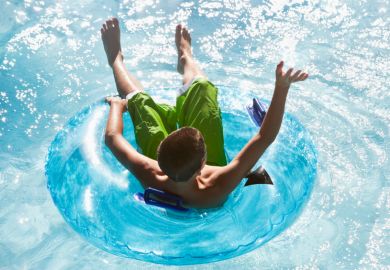 Student or teenager enjoying lazy river in rubber ring