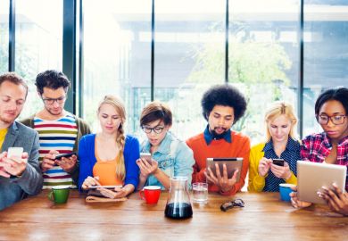 Young people using smartphones and tablets